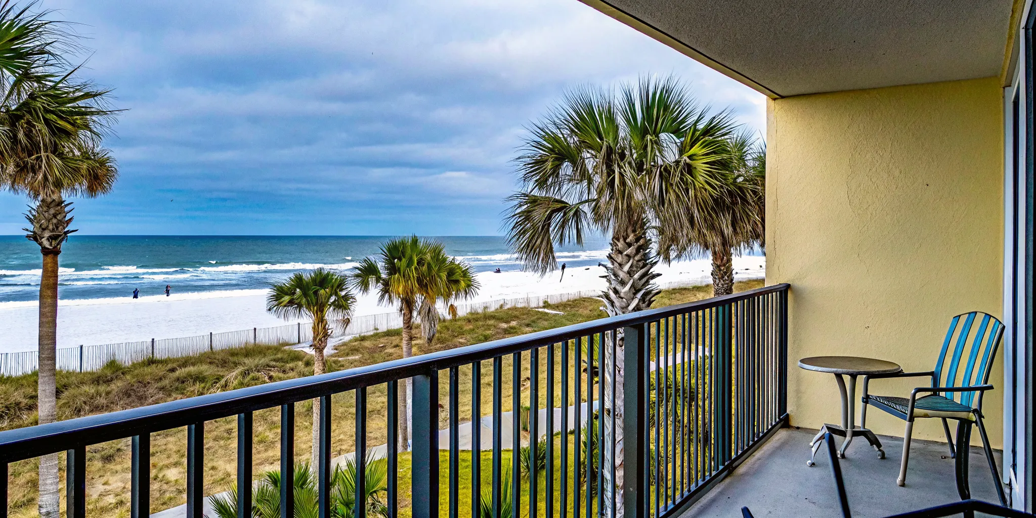 Cozy beachfront condo balcony overlooking a quiet white sand beach in Panama City Beach during a serene winter morning