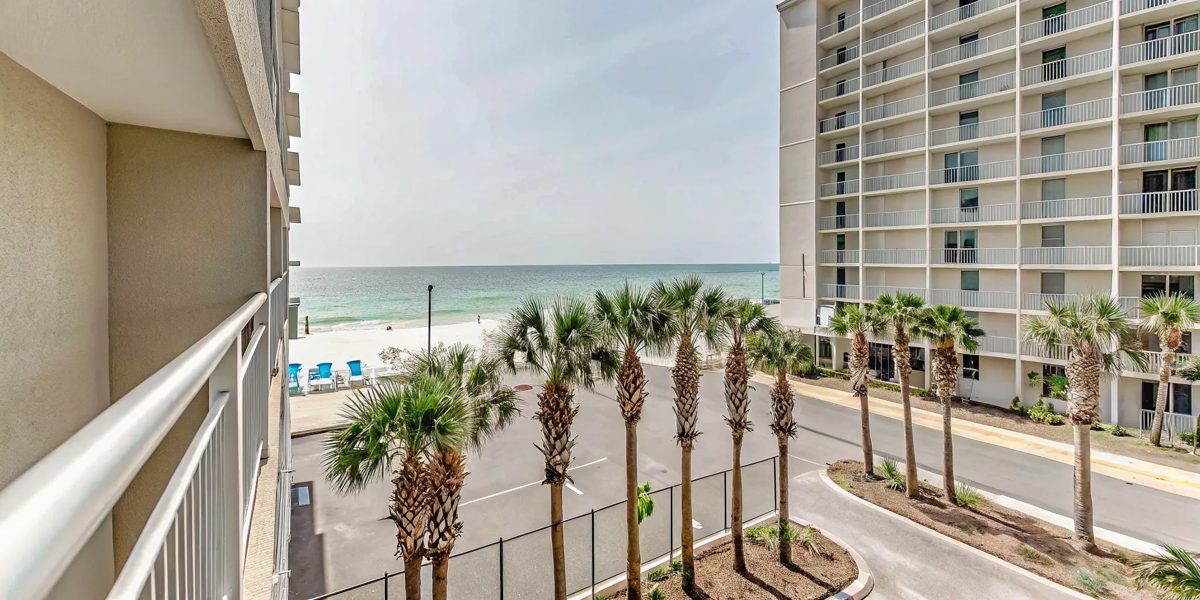 Luxury beachfront vacation rental condo in Panama City Beach Florida with modern exterior and palm trees